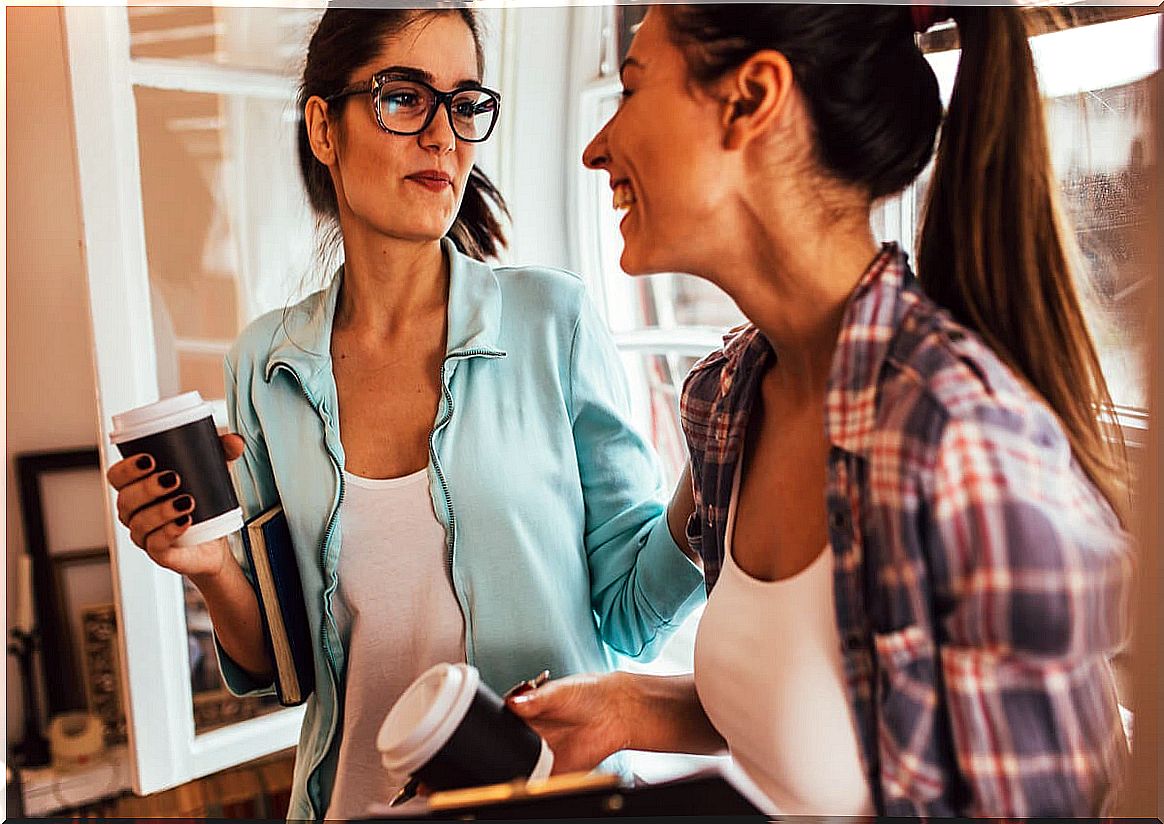 Friends chatting while drinking coffee