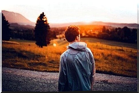 young man observing landscape