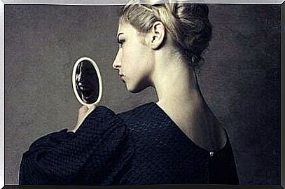 woman looking in the mirror