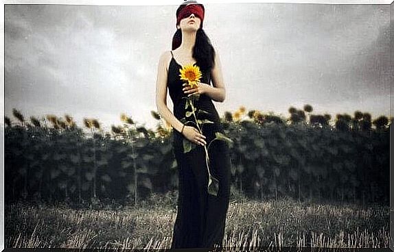 woman holding sunflower