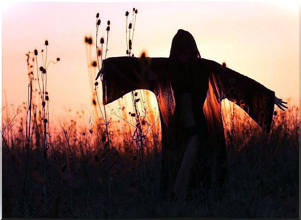 Woman with a cape at dusk