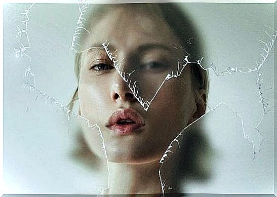 woman in front of broken glass