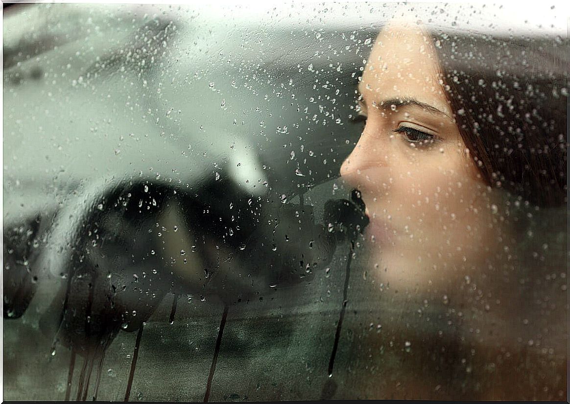 woman in front of wet window