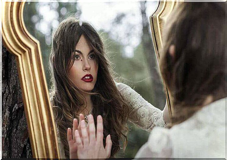 woman looking in the mirror