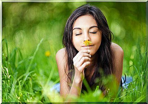 woman smelling flower