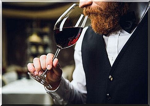 man sniffing wine