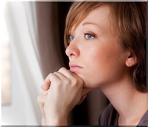 thoughtful woman looking out the window