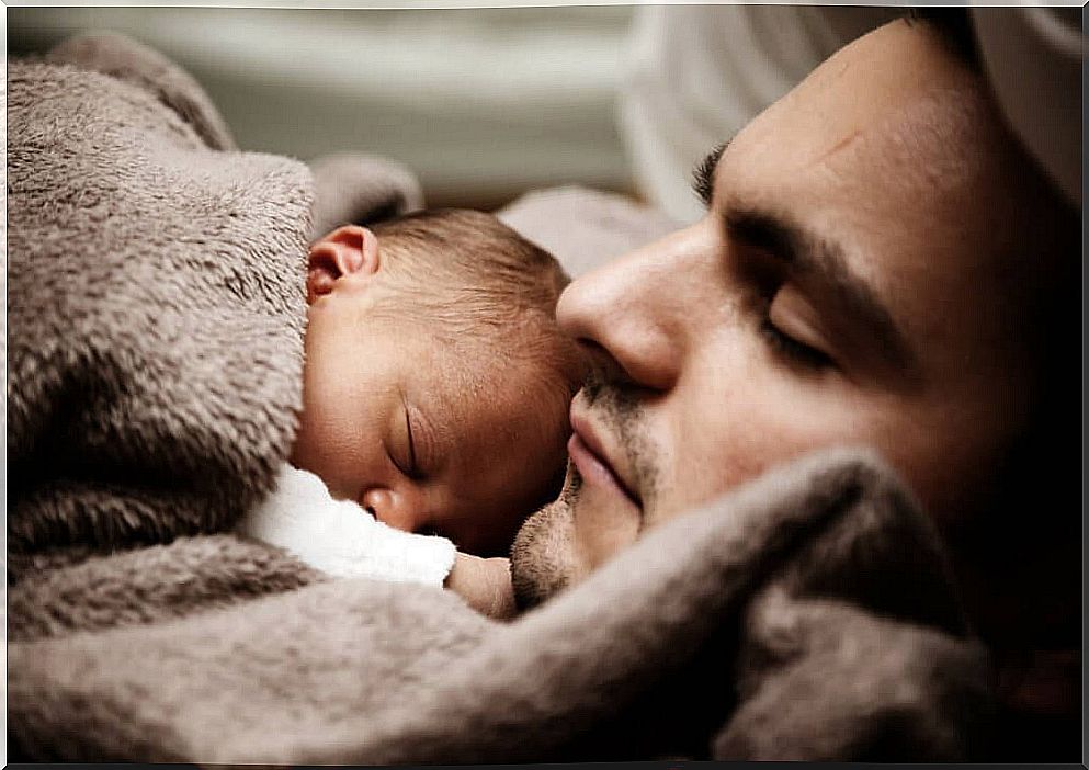 father sleeping with his baby