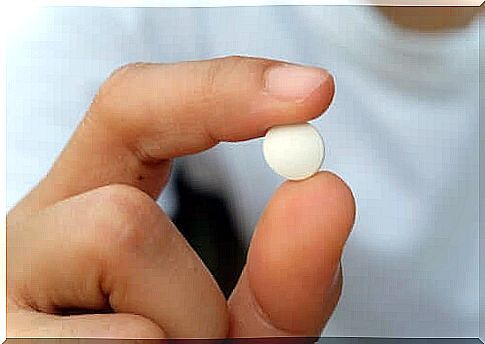 person holding pill