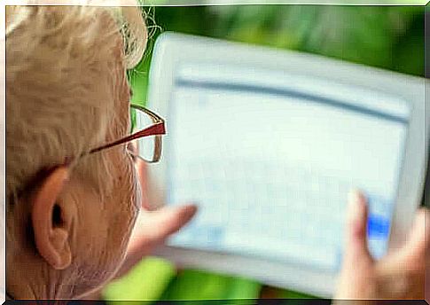 Elderly woman with tablet in hands